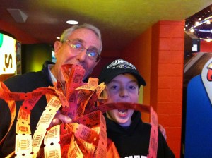 SCORE! Steven hits the jackpot at Funland with over 1,000 tickets and ends up with a mug and two pieces of candy.