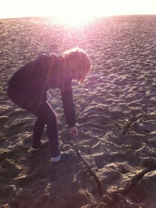 Ever the designer, Livvie redesigns the beach.